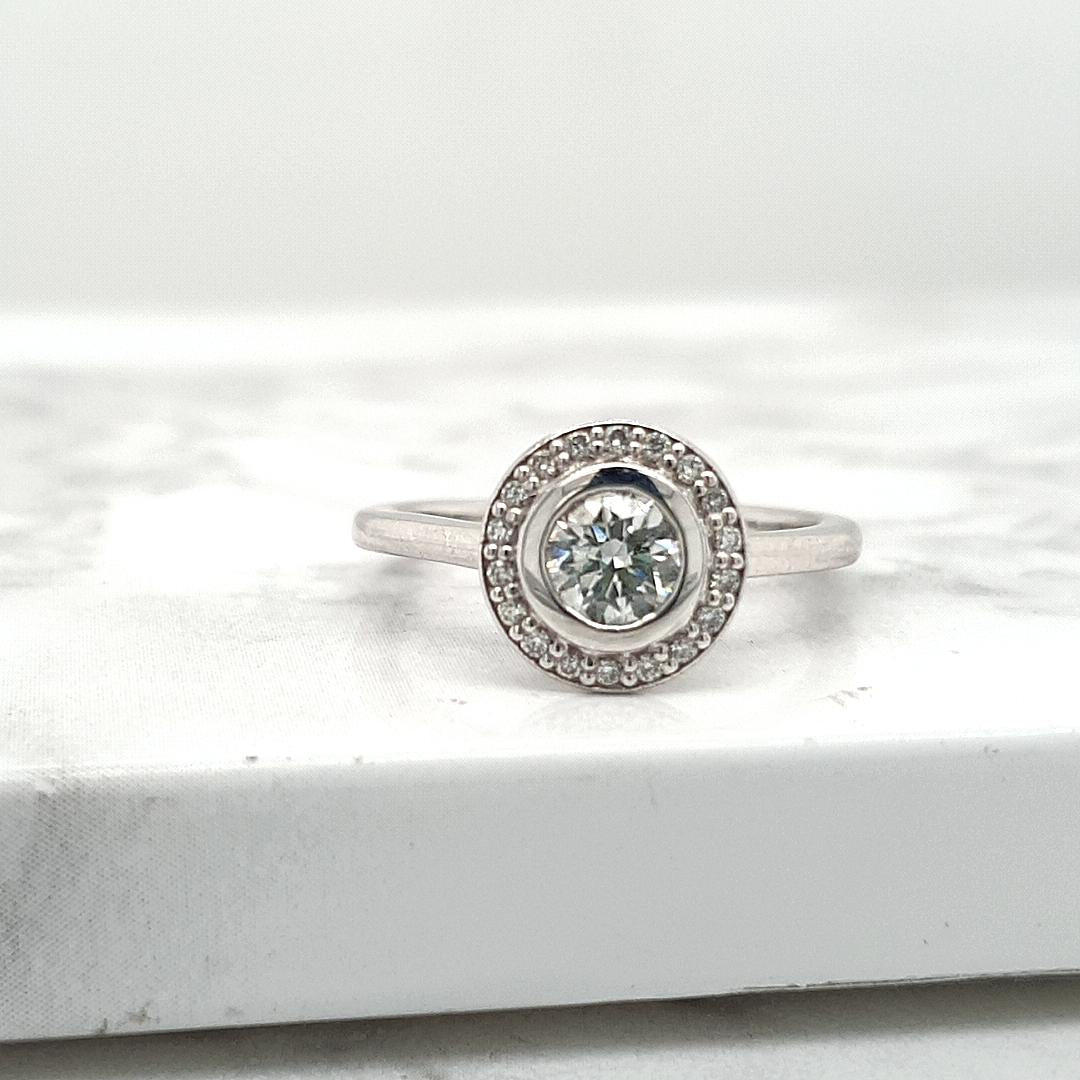 18ct White Gold 0.51ct Round Brilliant Bezel Set Diamond with 0.14ct Accent Round Brilliant Diamond Halo Ring
