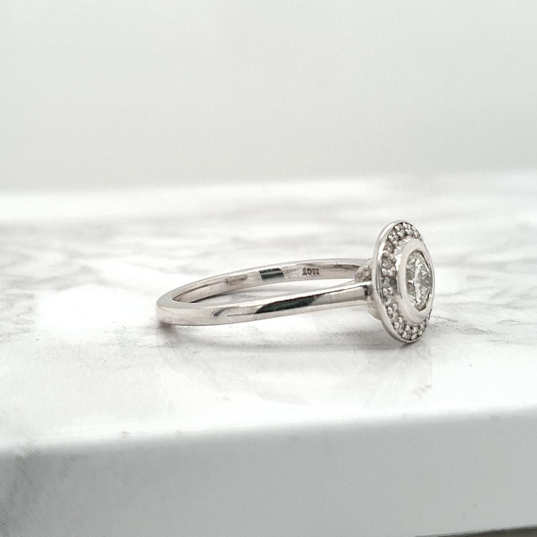 18ct White Gold 0.51ct Round Brilliant Bezel Set Diamond with 0.14ct Accent Round Brilliant Diamond Halo Ring