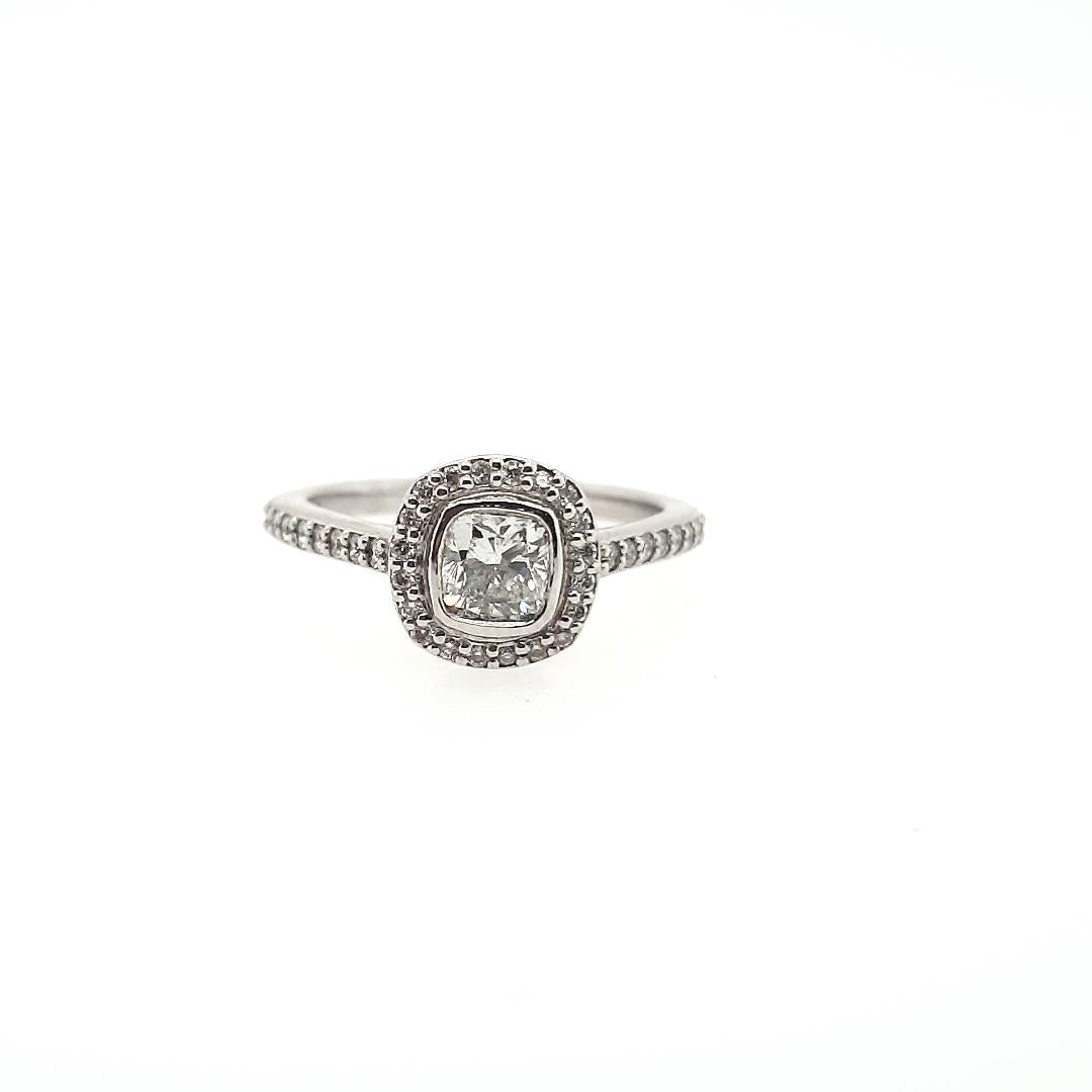 18ct White Gold 0.52ct Cushion Cut Bezel Set & 0.24ct Accent Round Brilliant Claw Set Halo with Shoulder Diamond Ring