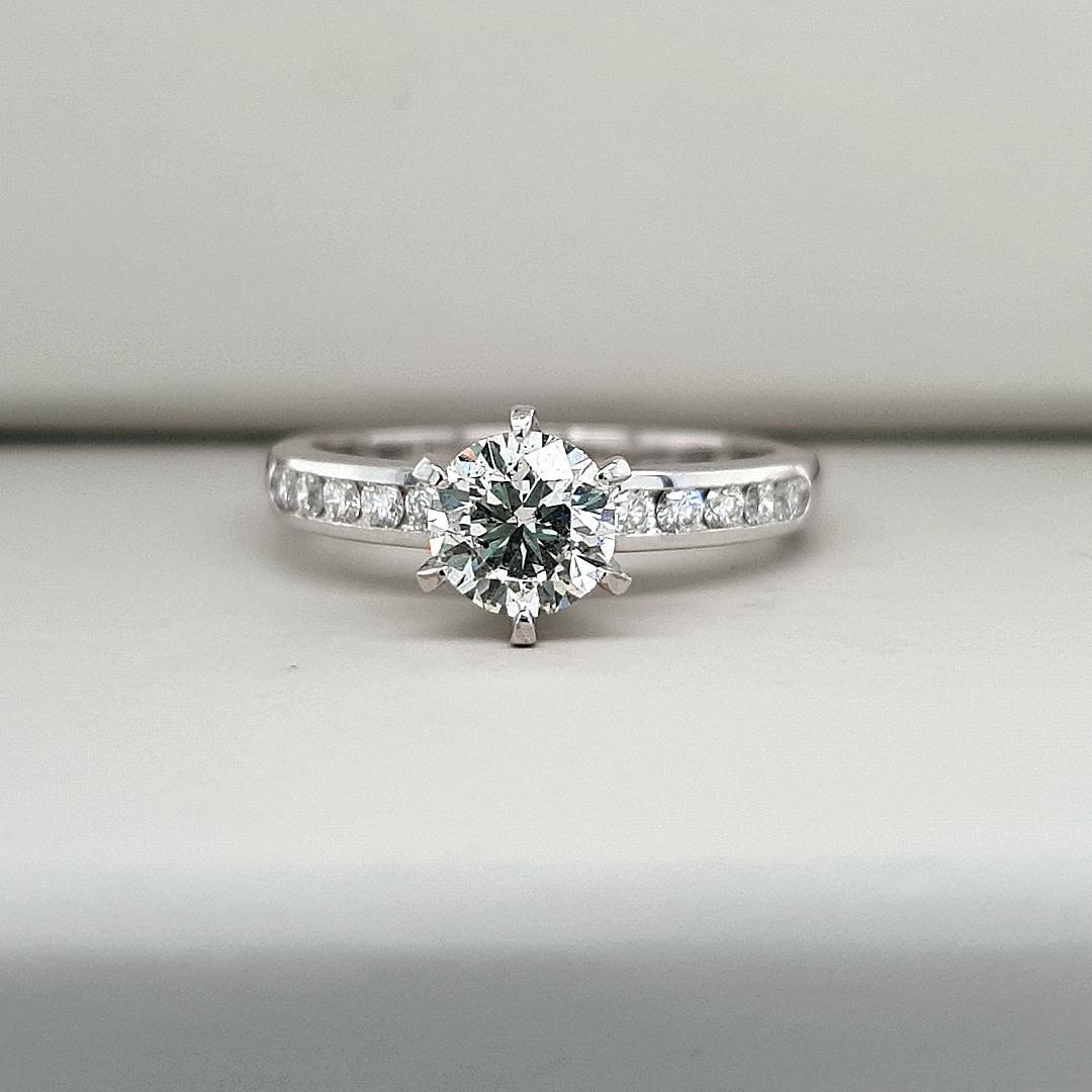 18ct White Gold 1.00ct Round Brilliant Centre Diamond Claw Set with Accent Diamonds Channel Set Ring