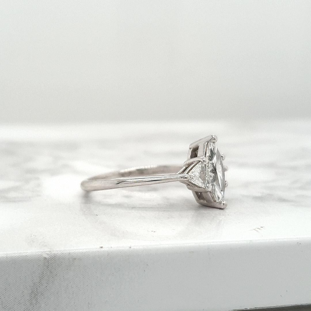 18ct White Gold 0.71ct Marquise Cut Diamond with 0.21ct Accent Trilliant Cut Diamond Claw Set Three Stone Ring