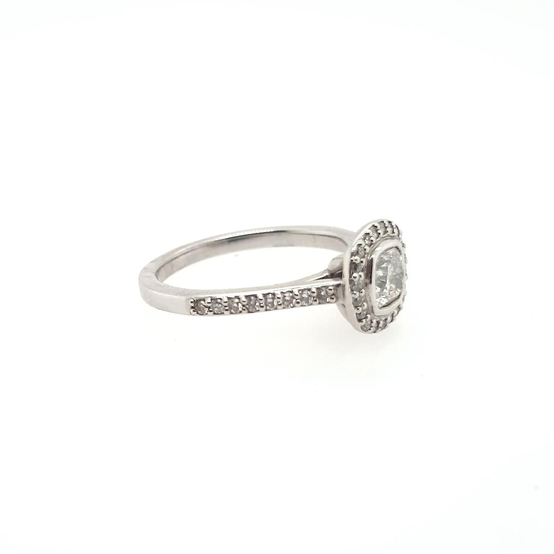 18ct White Gold 0.52ct Cushion Cut Bezel Set & 0.24ct Accent Round Brilliant Claw Set Halo with Shoulder Diamond Ring